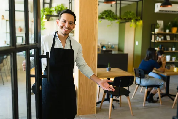 Greeting Clients Handsome Young Man Business Owner Smiling Opening Door — Stock Photo, Image