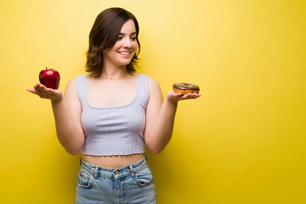 Hungry Young Woman Sugar Cravings Holding Red Apple Chocolate Donut — Stock Photo, Image