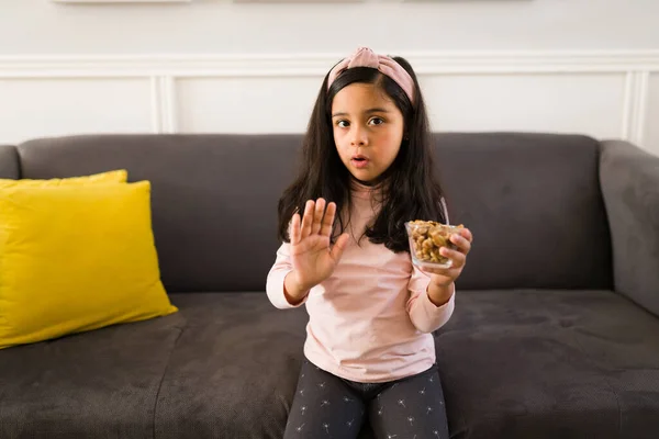 動揺した子供は軽食を食べたくありません 悲しい女の子拒否食べるナッツとピーナッツで家 — ストック写真