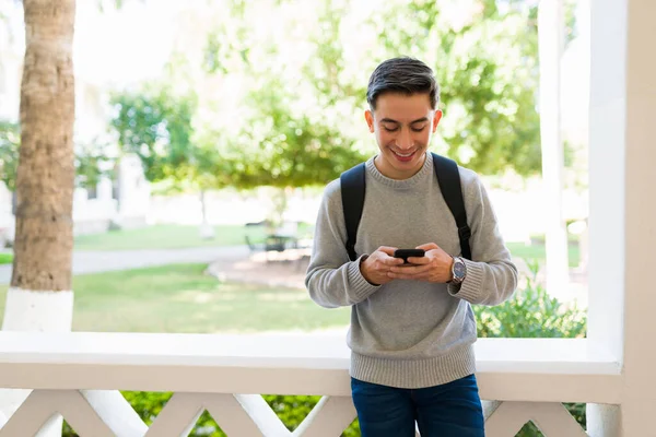 Atraktivní Šťastný Muž Smskuje Svém Smartphonu Zatímco Přestávce Mezi Jeho — Stock fotografie