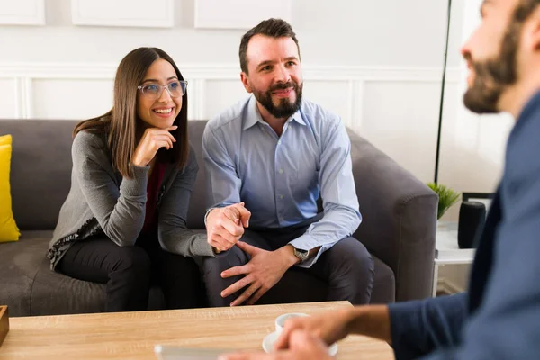 Cheerful Couple Holding Hands While Listening Financial Advisor Real State — Stok fotoğraf