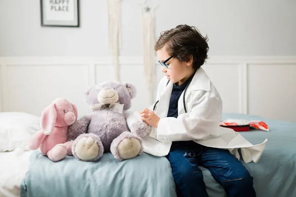 梦想成为一名医生 可爱的男孩希望从事医学职业 并作为病人与泰迪熊玩耍 — 图库照片