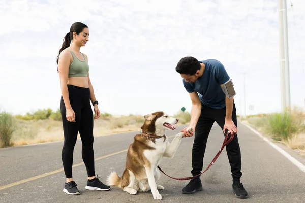 Fit Young Man Teaching Trick His Dog While Running Outdoors — Stockfoto