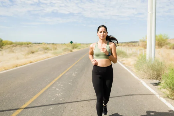 Fitness Young Woman Wearing Sportswear Running Deserted Road Sunny Day — Fotografia de Stock