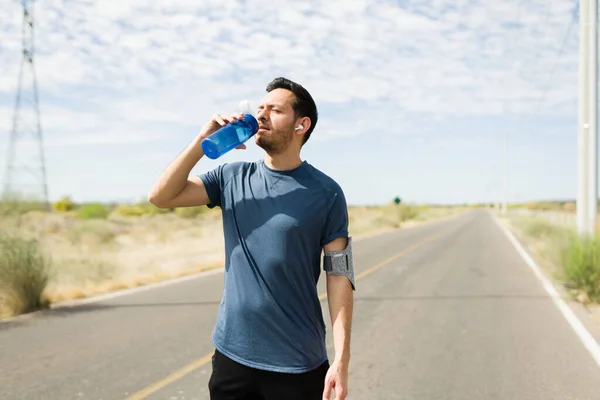 Thirsty Latin Man Drinking Water Hot Day While Running Deserted — Stok fotoğraf
