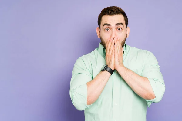 Surprised Young Man Covering His Mouth While Trying Scream Listening — Stockfoto