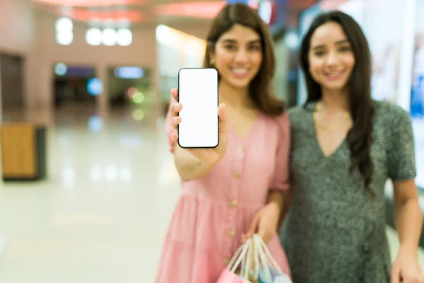 Focus Foreground Two Cheerful Young Women Holding Smartphone Doing Online — Stock Photo, Image