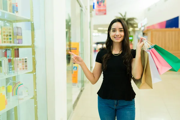 Portrait Happy Young Woman Carrying Shopping Bags Pointing Store Mall — Stock Photo, Image