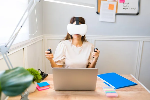 Professional woman wearing virtual reality glasses and using immersive technology for her telecommute job