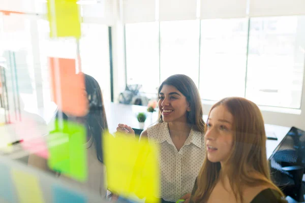Cheerful Multiracial Women Writing Sticky Notes Doing Brainstorming While Working — Stockfoto