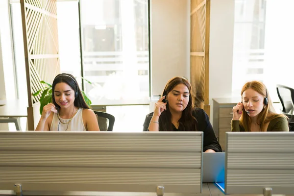 Young Diverse Women Wearing Headsets Making Calls While Working Sales — Stockfoto