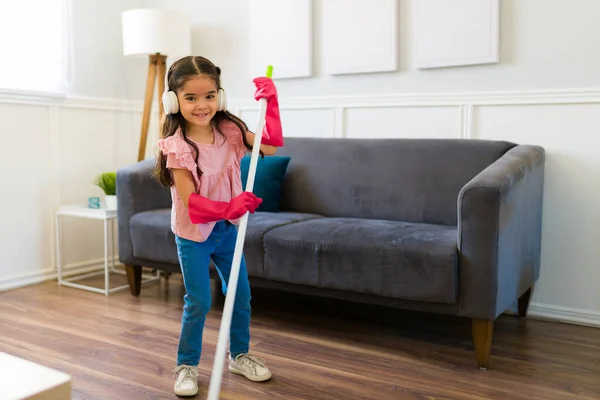 Beautiful Young Kid Smiling While Sweeping Living Room Helping Her — Stockfoto