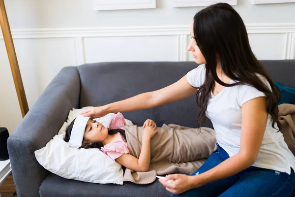 Sick Young Child Fever Cold Resting Sofa Her Worried Hispanic — Stok fotoğraf