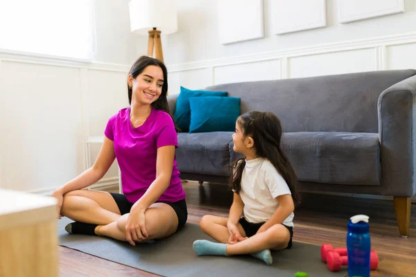 Active Young Mom Smiling Her Little Daughter While Exercising Yoga — 图库照片