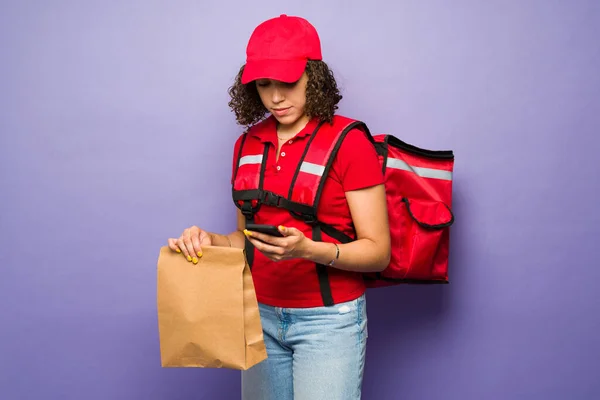 Female Delivery Person Curly Hair Red Unifrom Carrying Backpack Bag — Stock fotografie