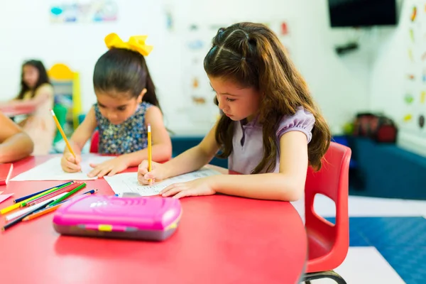 Smart Focused Little Girls Sitting Together Desk Learning Write Preschool — Stock fotografie