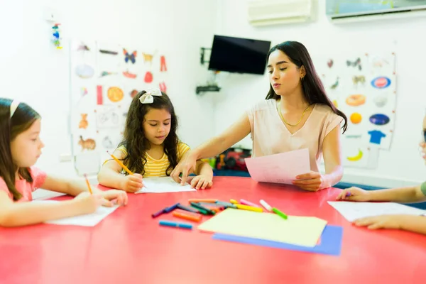 Preschool Children Female Teacher Explaining School Work Sitting Her Girls — стоковое фото