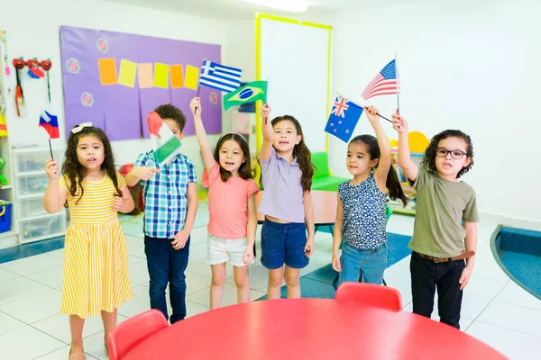Beautiful Mixed Race Children Learning World Countries Waving Flags Lesson — Zdjęcie stockowe