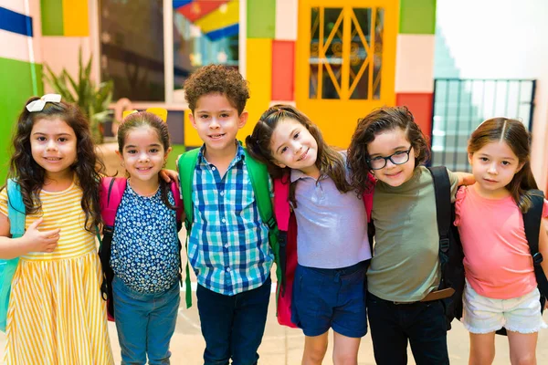 Diverse Happy Kids Backpacks Smiling Looking Camera While Arriving Kindergarten —  Fotos de Stock