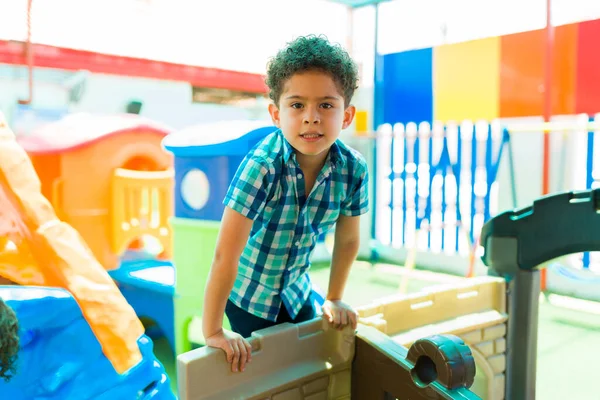 Cute Latin Elementary Boy Having Fun Playing Playground While Learning — Fotografia de Stock