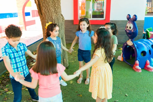 Happy Young Children Holding Hands Forming Circle Play Singing Game — Fotografia de Stock