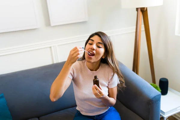High Angle Latin Young Woman Taking Cbd Oil Her Tongue — Foto Stock