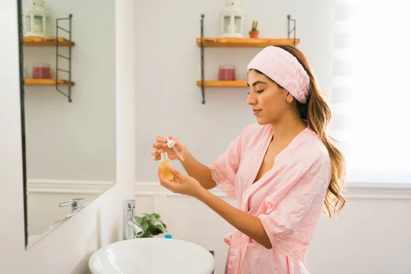 Hispanic Young Woman Bathrobe Doing Her Skin Care Routine Putting — Stockfoto