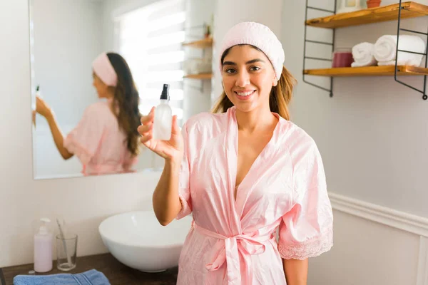 Portrait Attractive Hispanic Woman Bathrobe Showing Her Skincare Product Hyaluronic — Stok fotoğraf