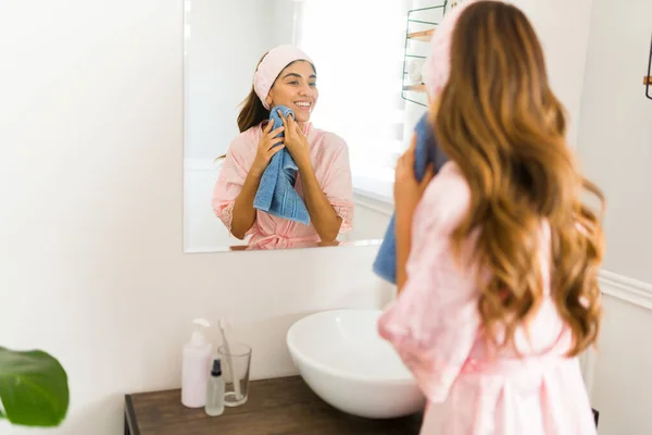 Glimlachende Spaanse Vrouw Kijkt Badkamer Spiegel Wassen Haar Gezicht Met — Stockfoto