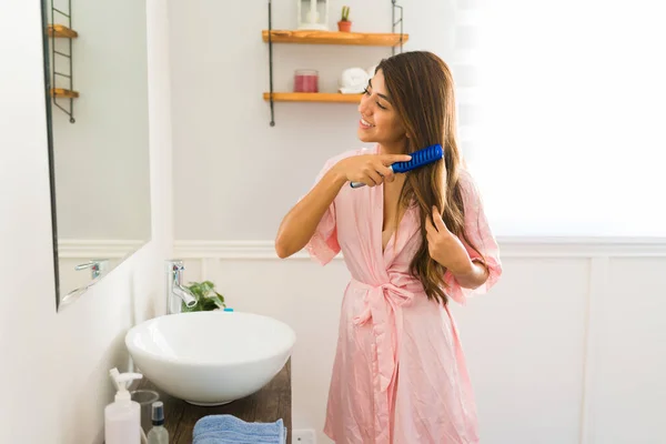 Happy Young Woman Brushing Her Long Hair Hairbrush While Smiling — Fotografia de Stock