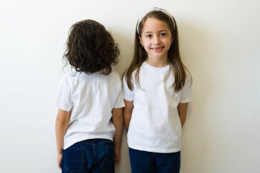 Beautiful kids with white shirts. Front and rear view of a mock up t-shirt for design print or logo for children