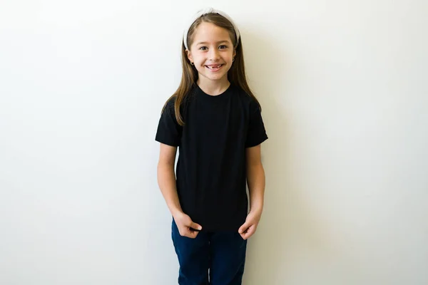 Happy Young Kid Smiling Showing Her Design Print Her Black — Stockfoto