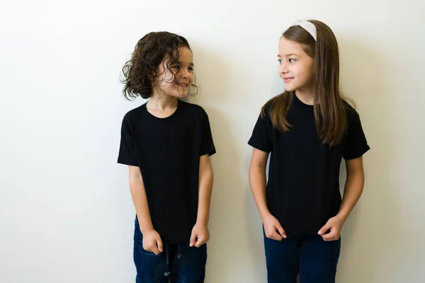 Beautiful Kids Looking Each Other While Showing Design Print Mockup — Stockfoto