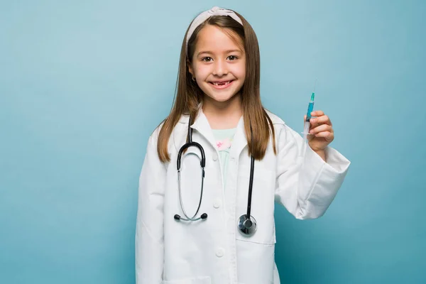 Studio Shot Cheerful Little Girl Playing Doctor Holding Syringe Give — Zdjęcie stockowe