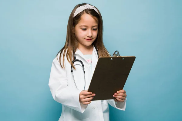 Beautiful Little Girl Holding Clipboard Wanting Study Medicine Standing Front —  Fotos de Stock
