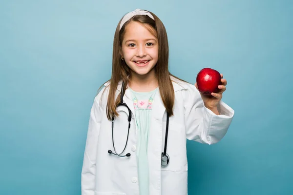 Portrait Excited Little Girl Aspiring Nutritionist Holding Healthy Apple Smiling —  Fotos de Stock