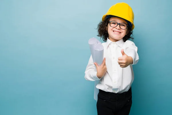 Smiling Kid Looking Excited Making Thumbs While Dreaming Architect Working — Zdjęcie stockowe