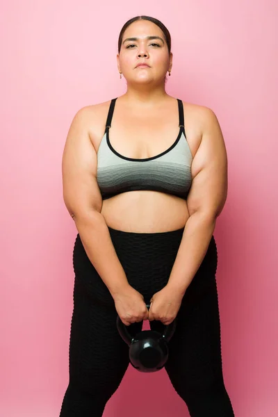 Sporty Obese Woman Looking Determined While Exercising Kettlebell Weight Cross — Photo