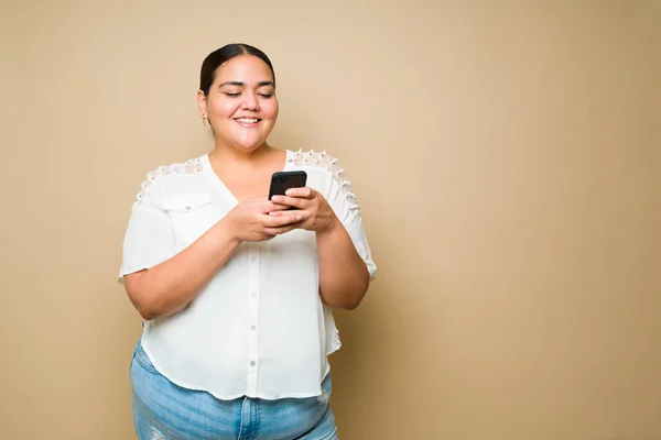 Studio Shot Cheerful Young Woman Laughing While Online Texting Looking — 图库照片