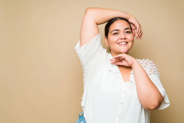 stock image Confident cheerful woman smiling and looking happy while having fun against a yellow background with copy space