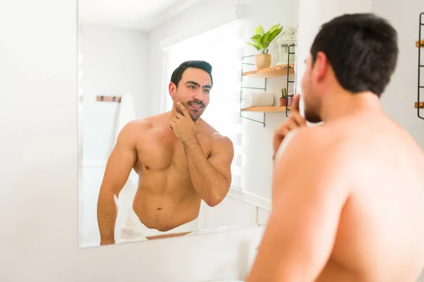 Smiling Athletic Young Man Feeling Happy While Grooming Using Skin — Foto de Stock