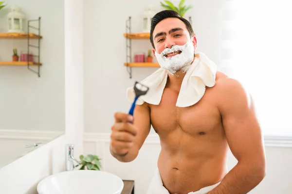 Cheerful Muscular Man Shaving Cream His Face Using Disposable Razor — 스톡 사진