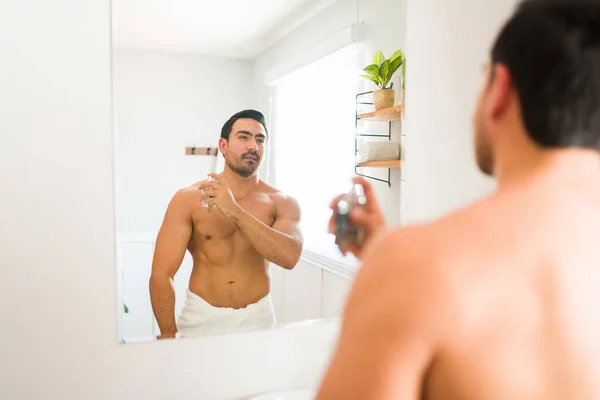 Latin Athletic Shirtless Man Using Fragrance Spray Body Lotion While — Stockfoto