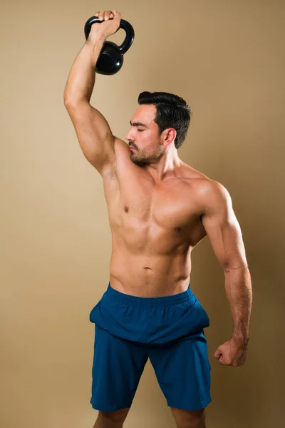 Strong Caucasian Young Man Weight Lifting Kettlebell Looking His Bicep — Stock Photo, Image
