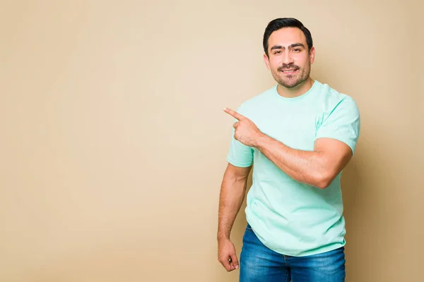 Cheerful Attractive Man Smiling Pointing His Finger Copy Space Yellow — Foto Stock
