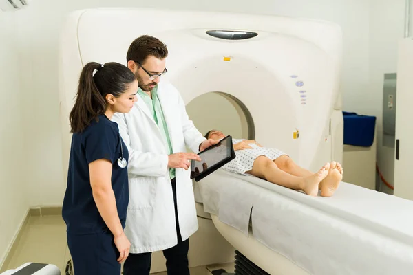 Male Caucasian Doctor Female Nurse Talking Diagnosis Results While Checking — Zdjęcie stockowe