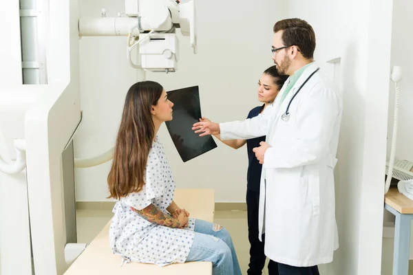 Concerned Doctor Radiologist Giving Medical Diagnosis While Looking Ray Image — Fotografia de Stock