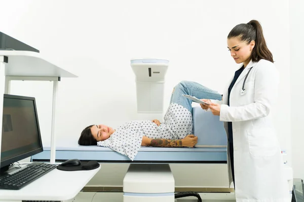 Caucasian Female Doctor Looking Medical Results Doing Densitometry Exam Sick — Foto Stock