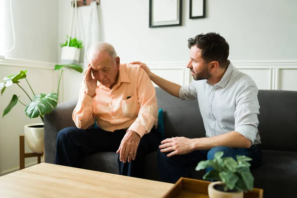Caucasian Son Looking Concerned Comforting His Depressed Senior Dad While — Stock Photo, Image