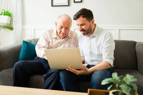 Smiling Caucasian Man Help His Senior Old Father Use Laptop — Stok Foto